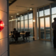 A business fire alarm system with a red alert light in a modern office.
