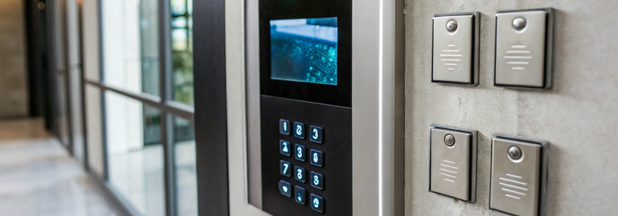Access control software displayed on a screen next to a secure entry keypad.