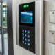 Access control software displayed on a screen next to a secure entry keypad.