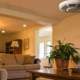 Home fire alarm system installation on a living room ceiling.