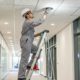 Technician performing a commercial fire alarm system installation.