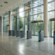 Top access control systems with secure entry gates in a modern office lobby.