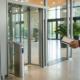 An employee uses a key card on a door access control system for business.