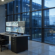 A commercial alarm monitoring station with a security professional watching multiple screens.