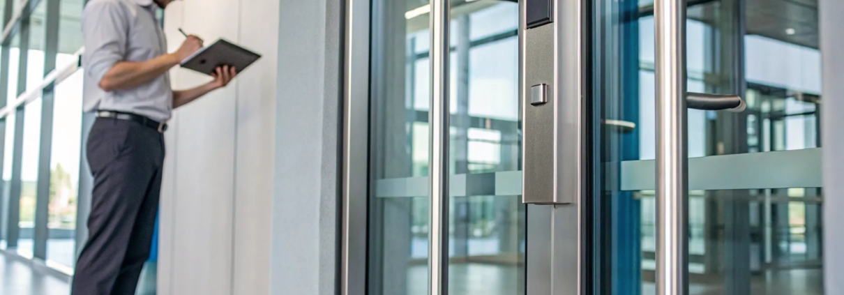 Magnetic lock on a glass door for a secure office access control system.
