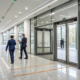 Door access control system installation on modern glass office doors.