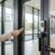 A person using a smartphone to unlock a small business access control system.