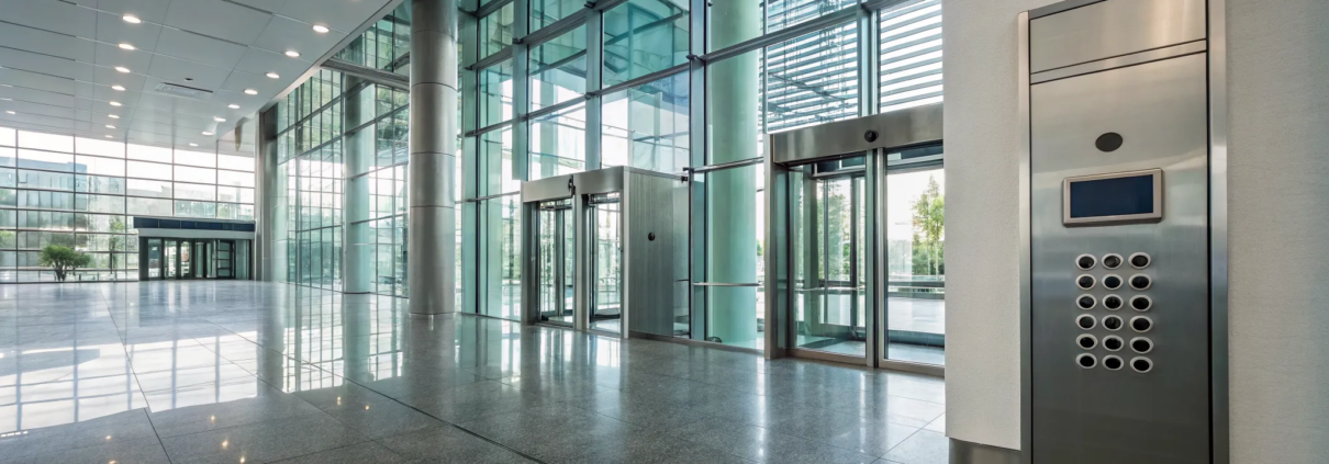 Office security systems, like this access control panel, securing a modern glass-door entrance.
