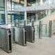 Business security access control systems securing an office lobby with modern turnstiles.