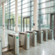 A business access control system with key card turnstiles securing a modern corporate office.