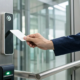 A professional uses a key card for secure entry into an office building.