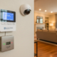 Home security alarm system keypad being installed in an Atlanta home with professional monitoring equipment visible