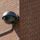 A professional security camera installation on an Atlanta building exterior.