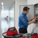 Technician inspecting a commercial fire alarm control panel in a Decatur Georgia business