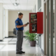 Technician checking fire alarm equipment in a Douglasville commercial building