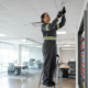 Fire alarm technician inspecting a commercial alarm system in a Sandy Springs office