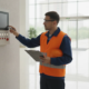 Fire protection technician inspecting a commercial fire alarm control panel in Smyrna, Georgia