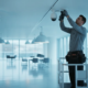 Professional technician installing a commercial IP surveillance camera in a modern Atlanta business space