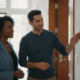 Atlanta homeowner reviewing an integrated alarm system with a security technician