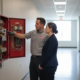 Fire alarm technician reviewing a commercial fire alarm panel with an Atlanta business manager