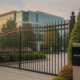 Commercial property entry gate with an access control reader beside the drive lane