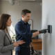 Technician reviewing an alarm keypad and sensor placement inside an Atlanta business
