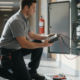 Fire alarm technician inspecting a commercial building control panel
