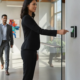 Office entrance with an employee using a credential reader beside a glass door