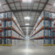 Fire alarm devices mounted in a clean warehouse aisle with high storage racks